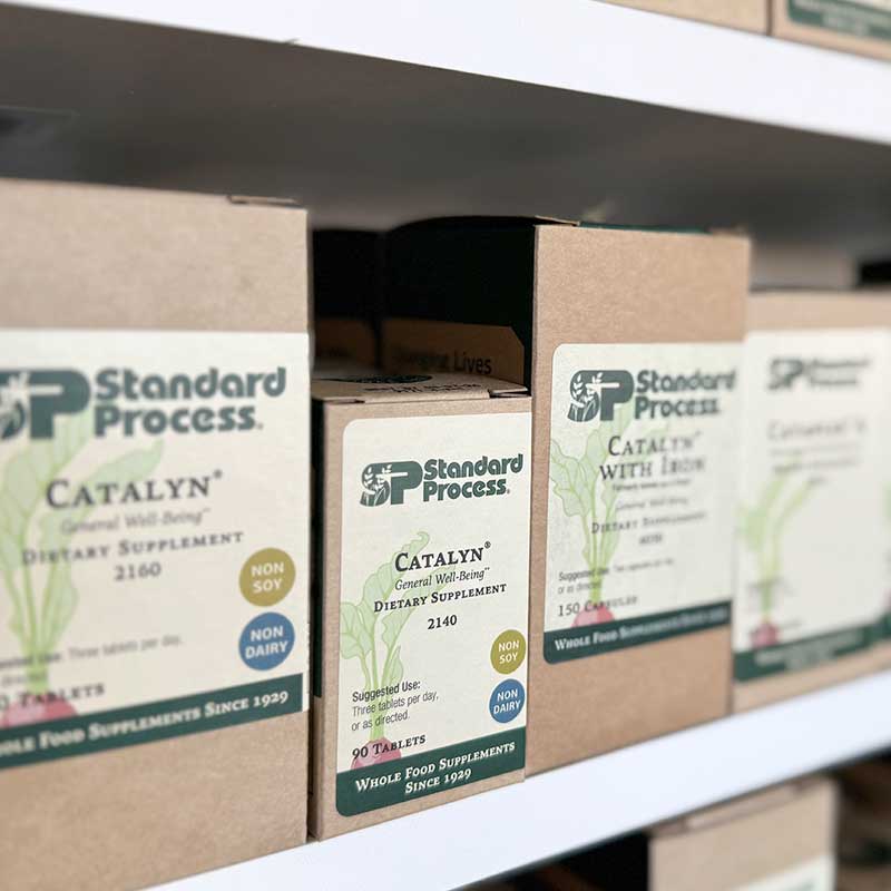 Standard Process supplements on shelves in boxes