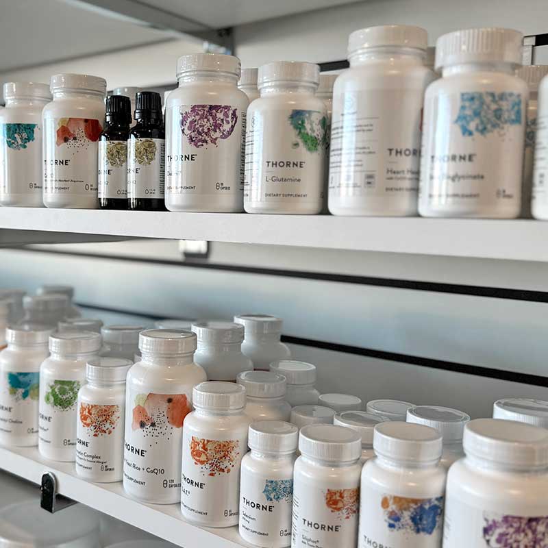 Thorne supplements on shelves in bottles and jars